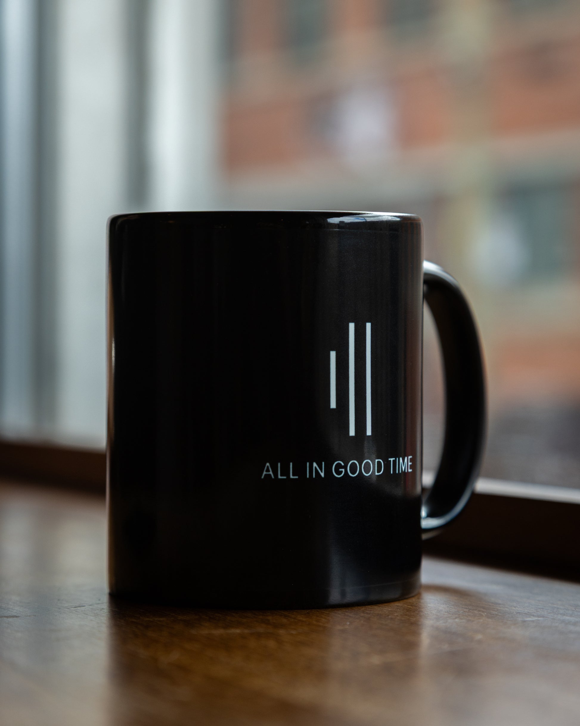 Close-up of Cowbell & Groove logo on minimalist black ceramic mug